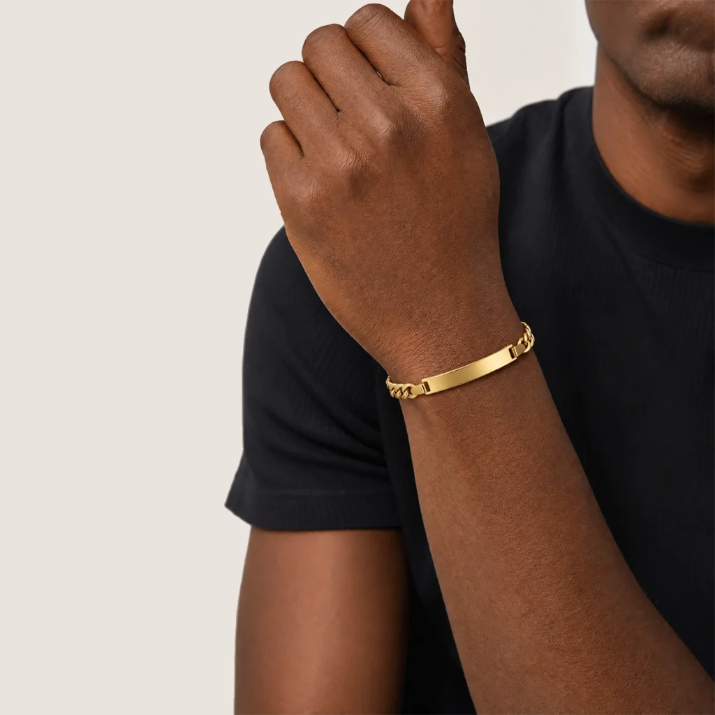 Pulseira chapa fígaro em ouro 18k no pulso, em foto com modelo